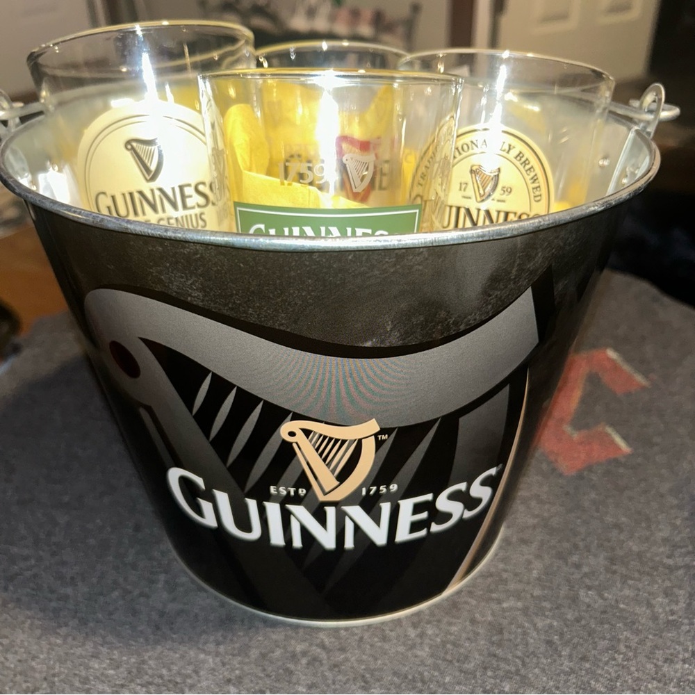 Guinness-branded ice bucket and glasses. 
The bucket has Guinness "ESTO 1759"